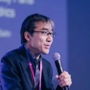 Prof. Saito speaking at an event.
